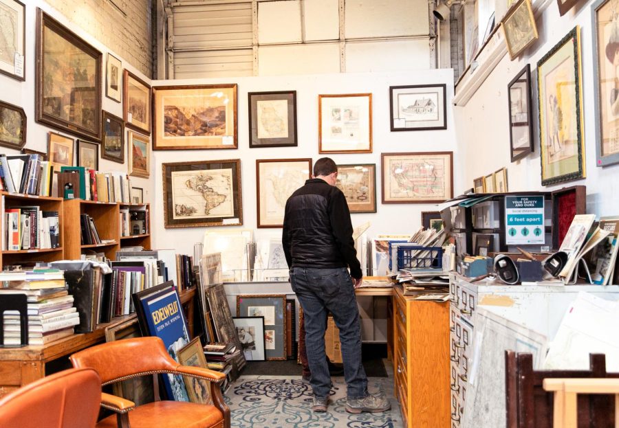 A customer spends a morning in Ken’s Rare Books looking at arts, prints, and other rare finds in Salt Lake City on Saturday, Feb. 26, 2022. (Rachel Rydalch | The Salt Lake Tribune) 