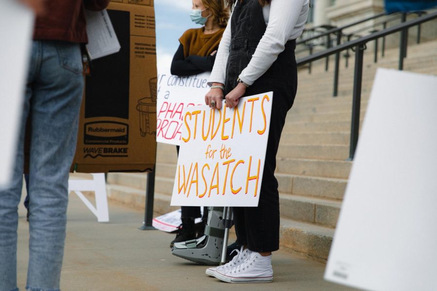 A sign brought by University of Utah students in favor of better solutions for Little Cottonwood canyon at the Capitol building in Salt Lake City on Wednesday, Feb. 9, 2022. (Photo by Rachel Rydalch | The Daily Utah Chronicle)