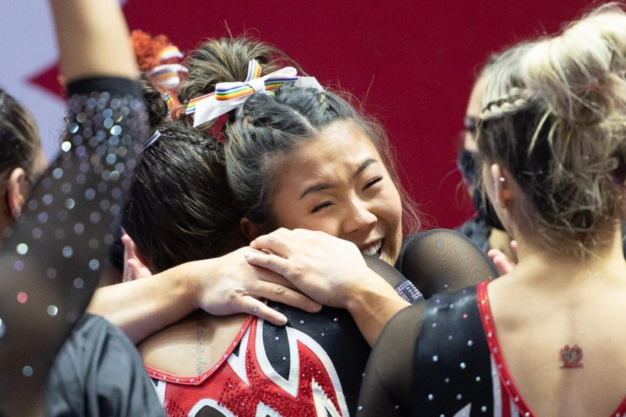 Cristal Isa celebrating with her teammate after a perfect beam routine against the OSU Beavers at the Jon. M. Huntsman Center in Salt Lake City, Utah on Wednesday, Feb. 18, 2022. (Photo by Jonathan Wang | The Daily Utah Chronicle)