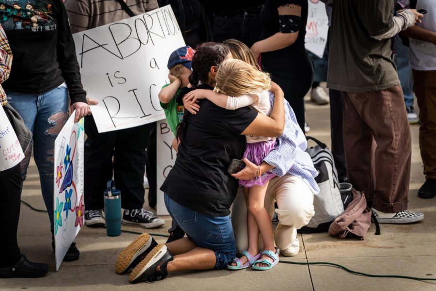 Children embrace their guardian at the protest against the potential overturn of Roe v. Wade at the Utah State Capitol on May 5, 2022. (Photo by Xiangyao Axe Tang | The Daily Utah Chronicle)