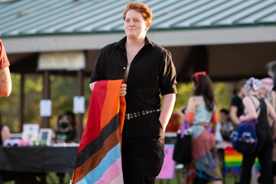 A Pride without Police participant holding the Progress Pride flag in Salt Lake City, Utah, on Friday, June 10, 2022. (Photo by Jonathan Wang | The Daily Utah Chronicle)