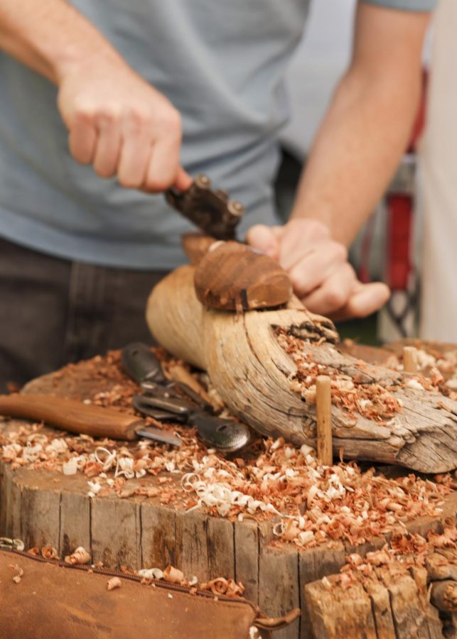 Troy Anderson carves a piece of wood at the Pioneer Park farmers market, Salt Lake City, Utah on Saturday, June 25, 2022. (Photo by Amen Koutowogbe | The Daily Utah Chronicle)