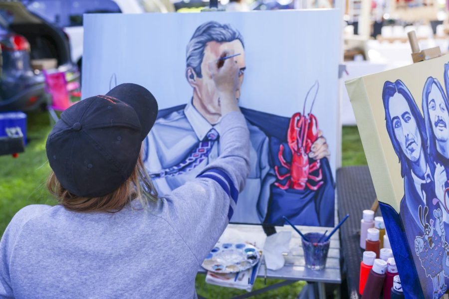 Jenna L. Rogan works on a painting at the Pioneer Park farmers market in Salt Lake City, Utah on Saturday, June 25, 2022. (Photo by Amen Koutowogbe | The Daily Utah Chronicle)
