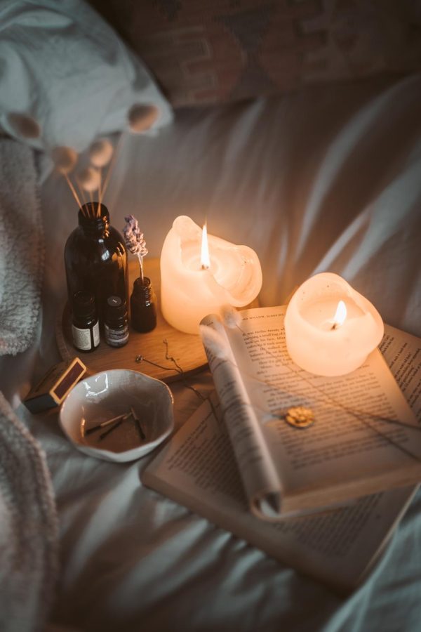 Cozy Candles and Book (Courtesy Taryn Elliott via Pexels)