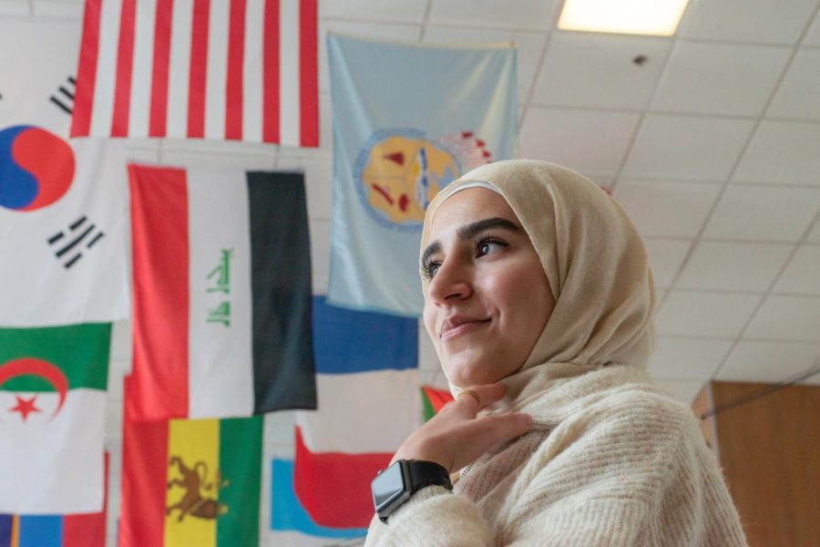 University of Utah marketing student and member of the Arab Student Association, Aya Hadid, stands in front of the flags inside of the A. Ray Olpin Union Building on campus in Salt Lake City on Jan. 28, 2023.