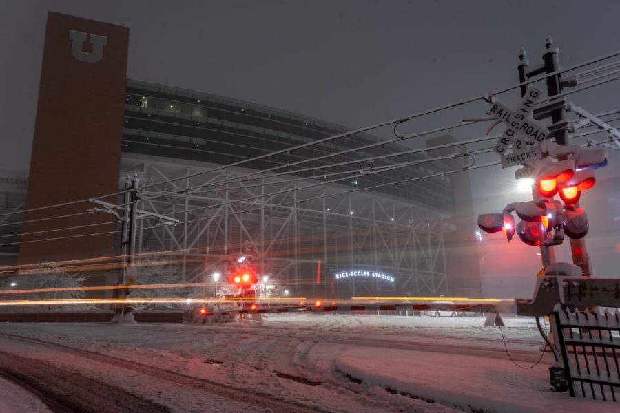 The UTA TRAX Red Line passing in front of the Rice-Eccles Stadium in Salt Lake City, Tuesday, Feb. 21, 2023. (Photo by Marco Lozzi | The Daily Utah Chronicle)
