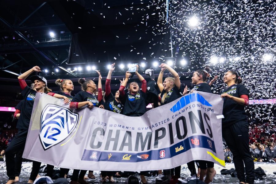 The Utah Red Rocks lift the trophy after winning the Pac-12 Women’s Gymnastics Champions title at Maverik Center in West Valley City, Utah on Saturday, March 18, 2023.