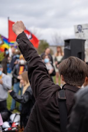 A protestor raised their fist during a chant outside the UCCU Center in Orem on Saturday, April 22, 2023. 