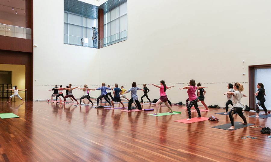 Art + Wellness participants practice yoga in UMFAs Great Hall (Courtesy of UMFA)