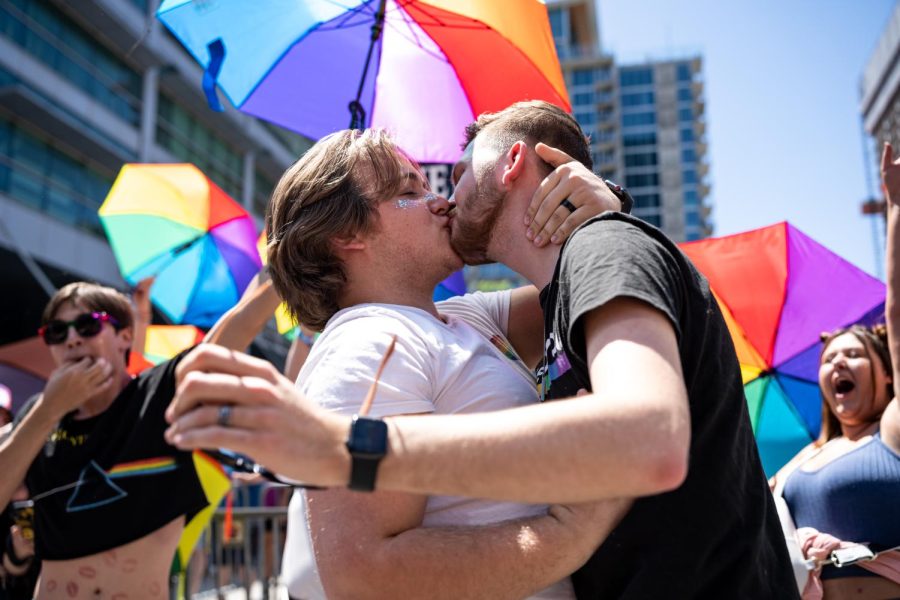 Two+parade-goers+kissing+in+front+of+the+Official+Street+Preachers+at+the+2023+Utah+Pride+Parade+in+downtown+Salt+Lake+City+on+June+4%2C+2023.