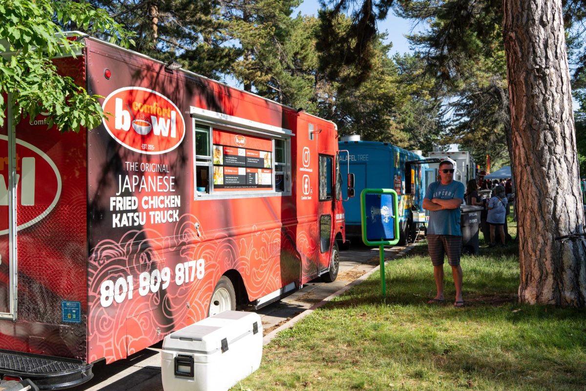A person standing by a food truck at the Food Truck Face Off at Liberty Park in Salt Lake City on Saturday, July 8, 2023. (Photo by Xiangyao Axe Tang | The Daily Utah Chronicle)