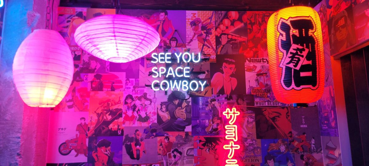 Anime themed booth with a neon sign that reads SEE YOU SPACE COWBOY from Cowboy Bebop. (Photo by Andre Montoya | The Daily Utah Chronicle)