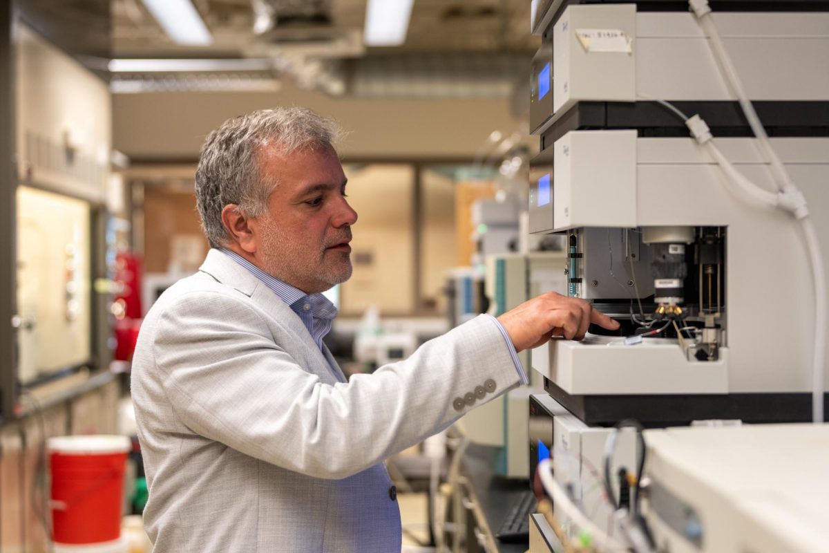 Vahe Bandarian explains the usage of a piece of equipment in a chemsitry lab in the Thatcher Building on the University of Utah campus in Salt Lake City on Aug. 18, 2023. (Photo by Xiangyao Axe Tang | The Daily Utah Chronicle)