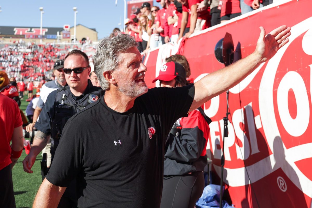 Utah head coach Kyle Whittingham high-fives fans after defeating the UCLA Bruins at Rice-Eccles Stadium in Salt Lake City on Saturday, Sept. 23, 2023. (Photo by Madeline Van Wagenen | The Daily Utah Chronicle)