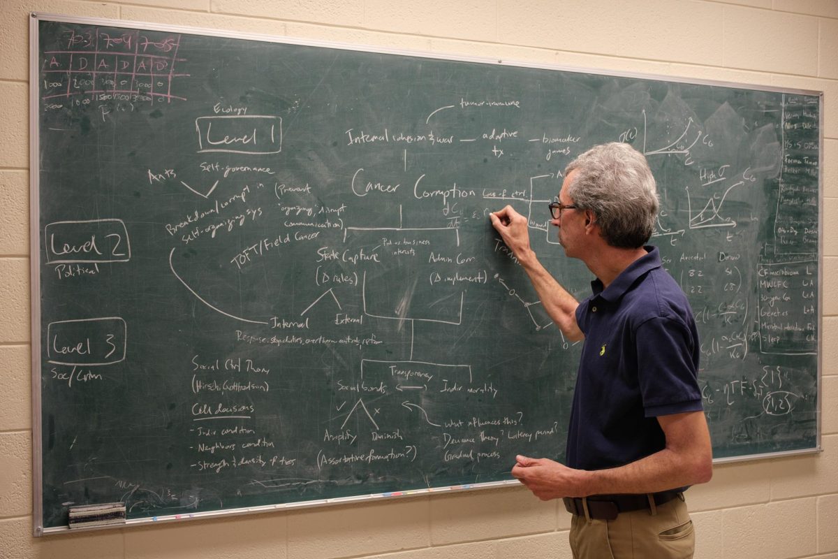 Fred Adler writes equations inside his office at the University of Utah in Salt Lake City on Sept. 5, 2023. (Photo by Marco Lozzi | The Daily Utah Chronicle)