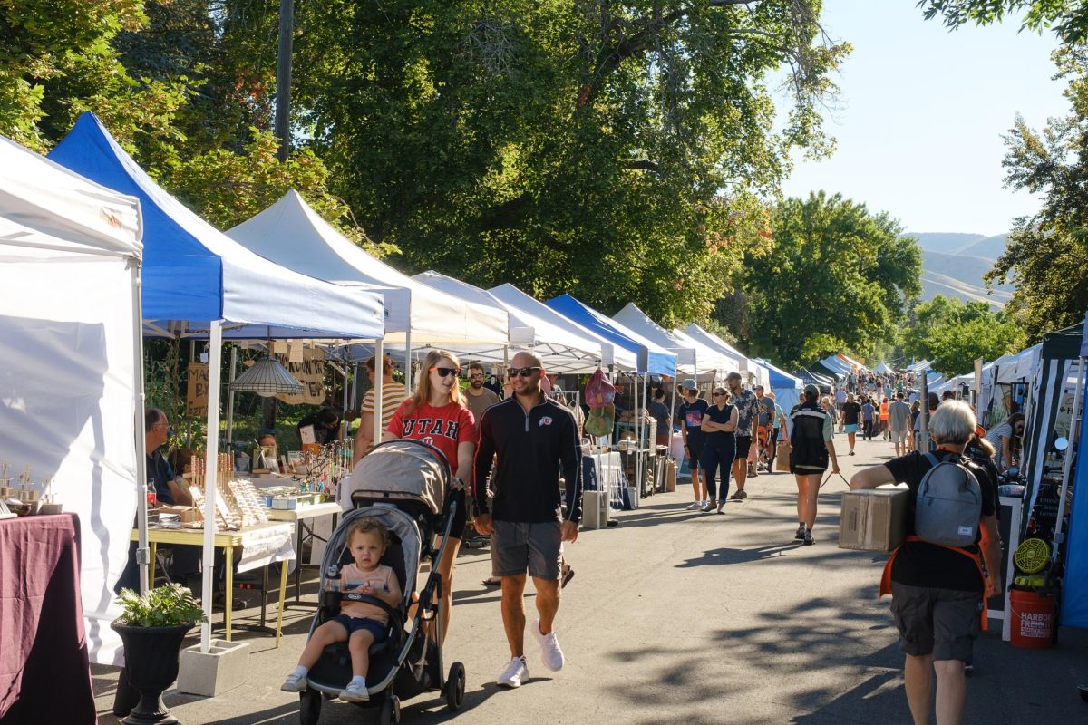 Market stalls set up along 7th Avenue during the Avenues Street Fair in Salt Lake City, Saturday, Sept. 9, 2023. (Photo by Marco Lozzi | The Daily Utah Chronicle)