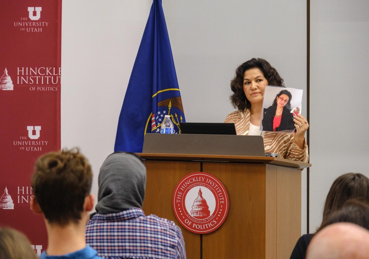 Rushan Abbas holds up a photo of her sister during the Hinckley forum held in the Hinckley Institute of Politics on the University of Utah campus in Salt Lake City on Wednesday, Sept. 20, 2023. (Photo by Marco Lozzi | The Daily Utah Chronicle)