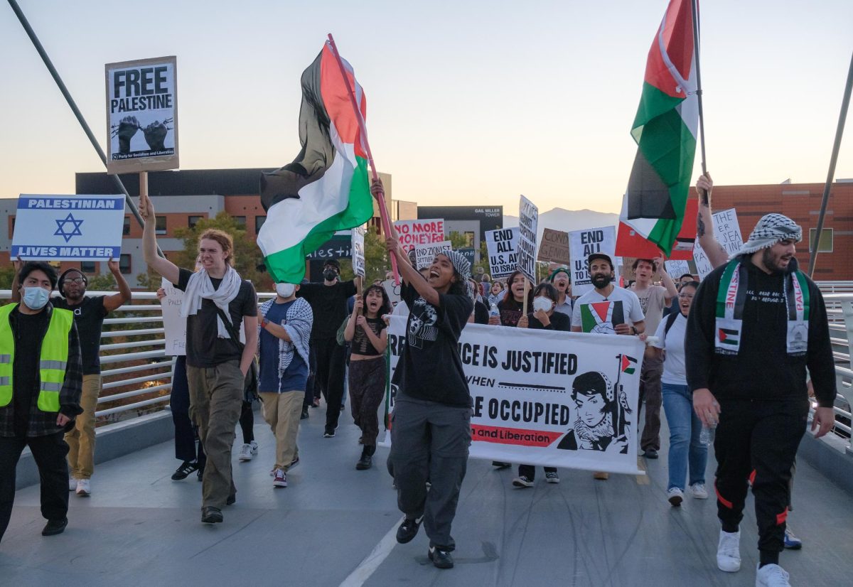 Pro-Palestine demonstrators march across the George S. Eccles Legacy Bridge in Salt Lake City during the All Out For Palestine rally on Friday, Oct. 20, 2023. (Photo by Marco Lozzi | The Daily Utah Chronicle)