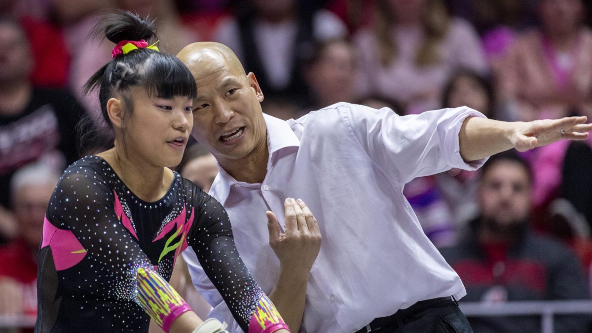 University of Utah womens gymnastics head coach Tom Farden talks with senior Kim Tessen before her performance on the floor in a dual meet versus the Stanford Cardinals at the Jon M. Huntsman Center in Salt Lake City, Utah on March 6, 2020.  (Photo by Kiffer Creveling | The Daily Utah Chronicle)