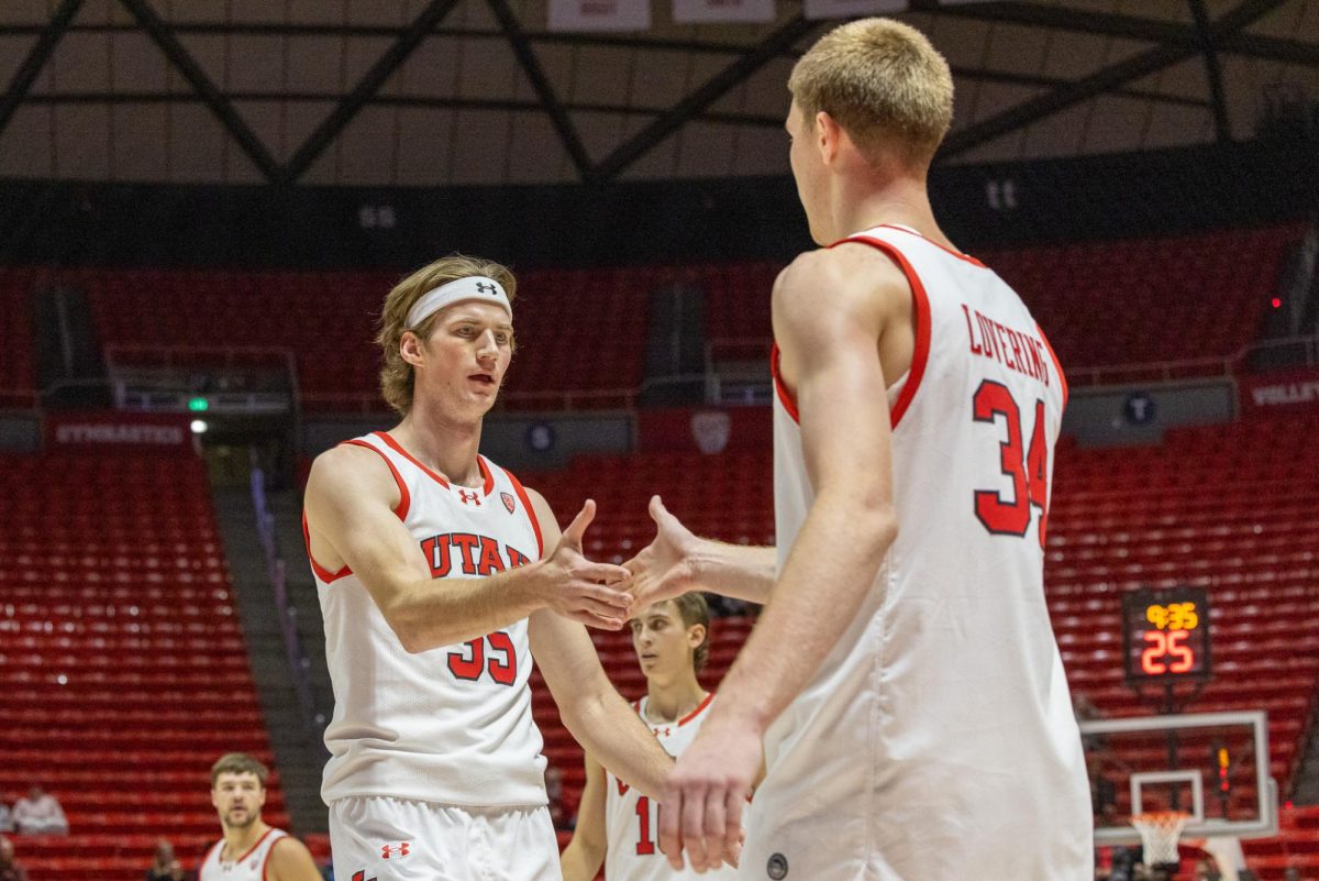Utah centers Brandon Carlson (35) and Lawson Lovering (34) exchange a handshake in the exhibition game versus Westminster Griffins at Jon. M. Huntsman Center in Salt Lake City on Nov. 1 2023. (Photo by Mary Allen | The Daily Utah Chronicle)