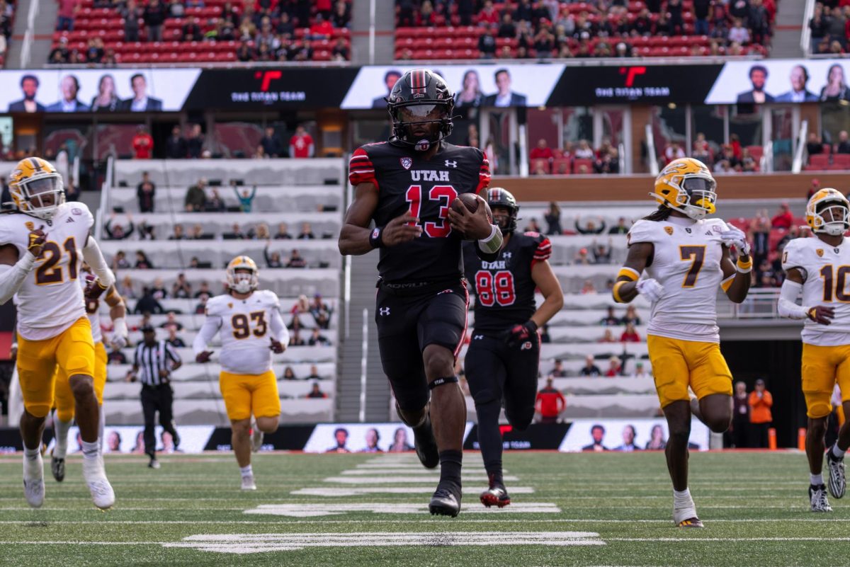 Utah quarterback Nate Johnson (13) runs the ball into the north end zone during the game against the Arizona State Sun Devils at Rice-Eccles Stadium in Salt Lake City on Saturday, Nov. 4, 2023. (Photo by Mary Allen | The Daily Utah Chronicle)