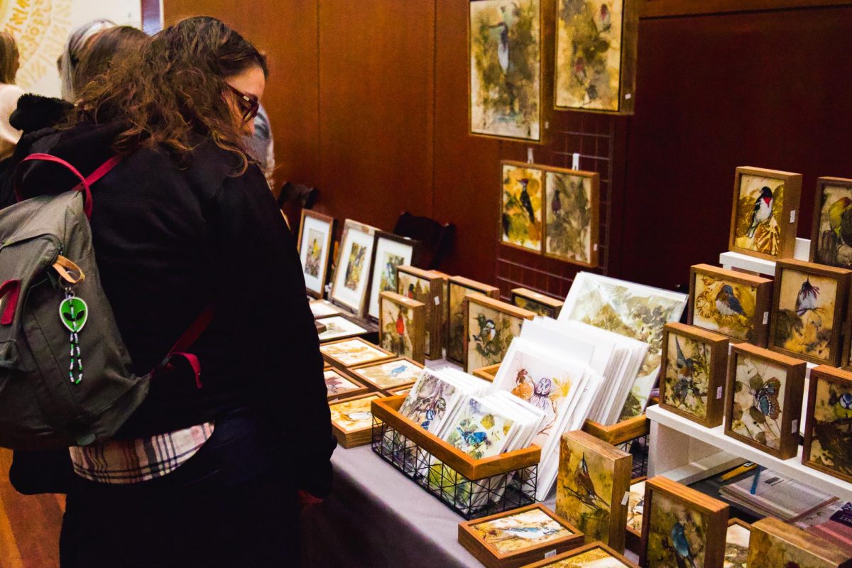 An attendee explores a local shop at the annual Utah Museum of Fine Arts’s Holiday Market in Salt Lake City on Saturday, Dec. 2, 2023. (Photo by Minh “Polaris” Vuong | The Daily Utah Chronicle)