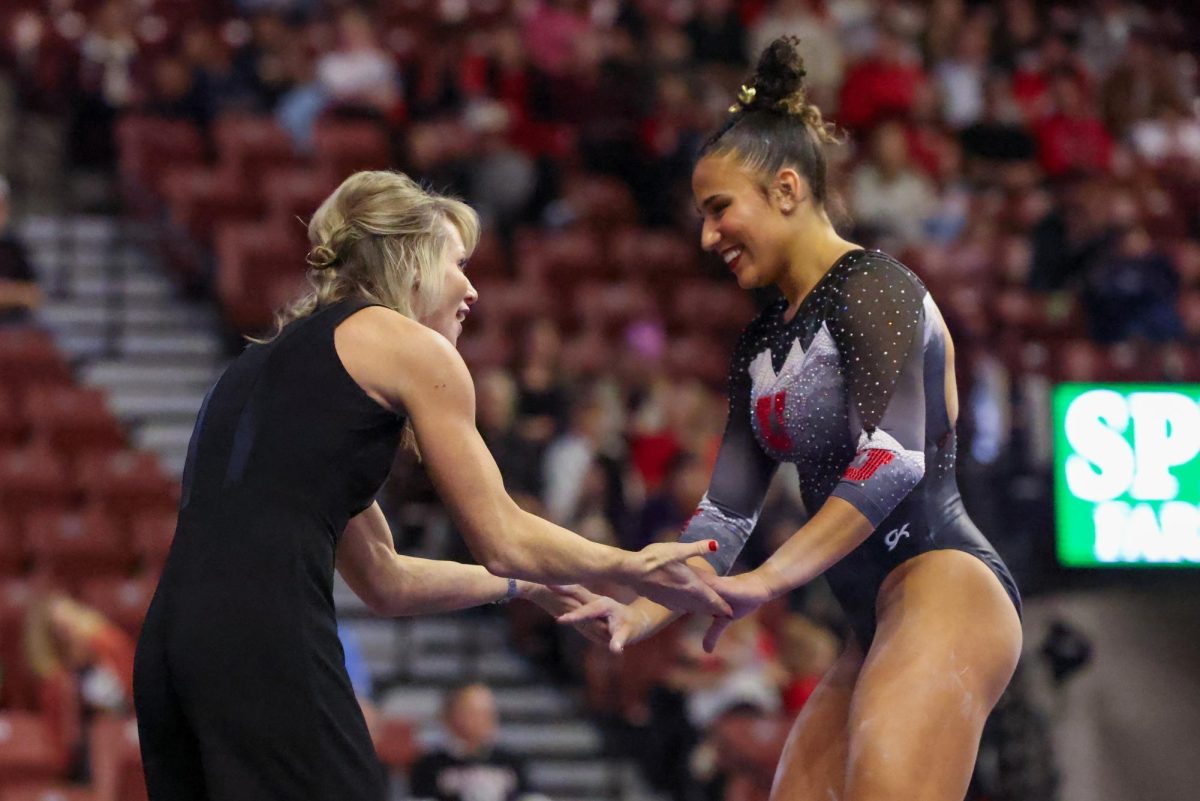 Utah gymnastics head coach Carly Dockendorf celebrates with Amelie Morgan after her beam routine at the Sprouts Farmers Market Collegiate Quad at Maverik Center in West Valley City, Utah on Saturday, Jan. 13, 2024. (Photo by Mary Allen | The Daily Utah Chronicle)