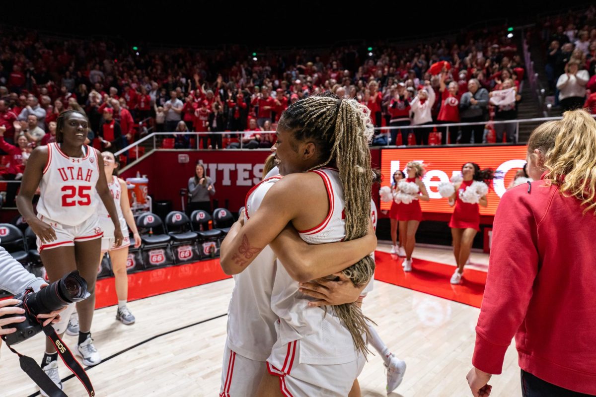 Utah forward Dasia Young (34) embraces her teammate after the win against the Colorado Buffaloes at the Jon M. Huntsman Center in Salt Lake City on Friday, Feb. 16, 2024. (Photo by Xiangyao “Axe” Tang | The Daily Utah Chronicle)