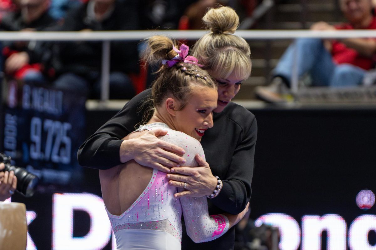 Utah gymnastics head coach Carly Dockendorf embraces gymnast Abby Paulson after her beam routine versus the Stanford Cardinal at the Jon M. Huntsman Center in Salt Lake City on Friday, Feb. 23, 2024. (Photo by Xiangyao “Axe” Tang | The Daily Utah Chronicle)