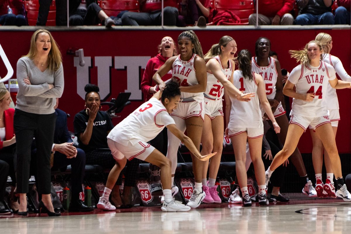 The Utah women’s basketball team celebrates after scoring against the Colorado Buffaloes at the Jon M. Huntsman Center in Salt Lake City on Friday, Feb. 16, 2024. (Photo by Xiangyao “Axe” Tang | The Daily Utah Chronicle)