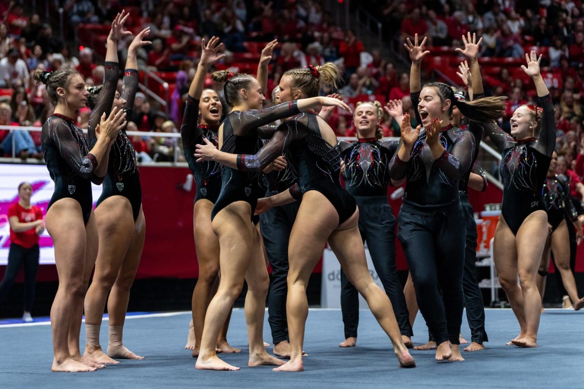 The Utah Red Rocks celebrate after Abby Paulson’s floor routine versus the Oregon State Beavers at the Jon M. Huntsman Center in Salt Lake City on Friday, Feb. 2, 2024. (Photo by Xiangyao “Axe” Tang | The Daily Utah Chronicle)