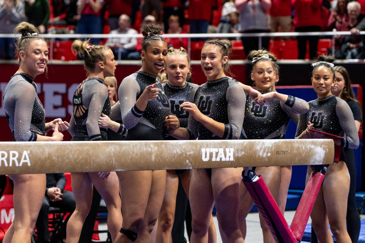 The Utah Red Rocks wait for gymnast Abby Paulson’s beam score versus Stanford Cardinal and Utah State Aggies at the Jon M. Huntsman Center in Salt Lake City on Friday, March 15, 2024. (Photo by Xiangyao “Axe” Tang | The Daily Utah Chronicle)