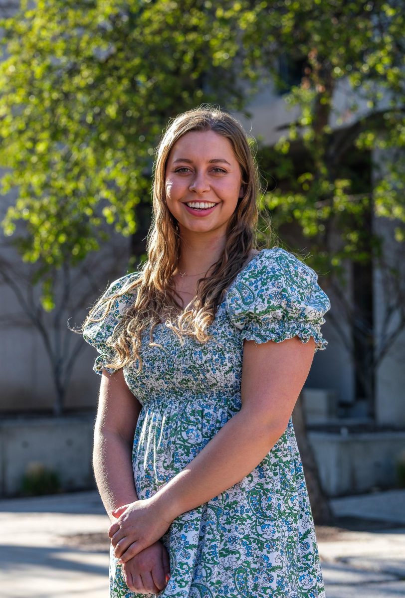 Allison Stuart, news writer of the Daily Utah Chronicle, poses for a photo outside the Student Services Building on the University of Utah campus in Salt Lake City on April 2, 2024. (Photo by Marco Lozzi | The Daily Utah Chronicle)
