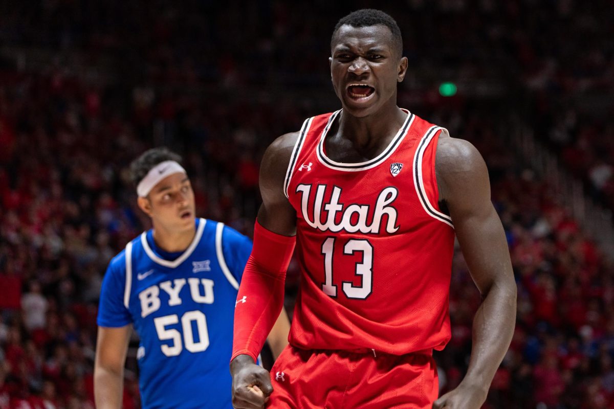 Utah center Keiba Keita (13) celebrates after scoring versus the BYU Cougars at the Jon M. Huntsman Center in Salt Lake City on Dec. 9, 2023. (Photo by Xiangyao Axe Tang | The Daily Utah Chronicle)