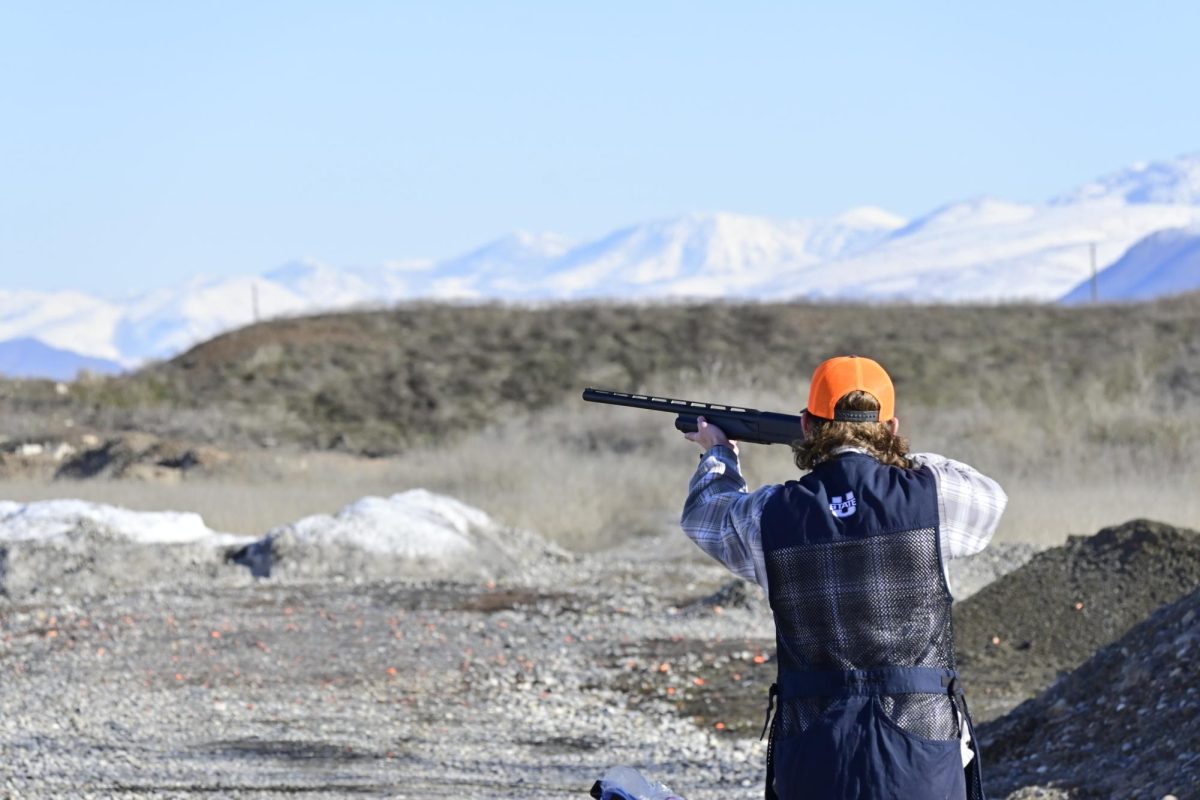 USU shotgun shooting club member Chandler Wilson aims and shoots at a clay target (not pictured) at Cache Valley Public Shooting Range on the morning of Feb. 17, 2024. (Photo by Joseph Holder | SLCCs The Globe)