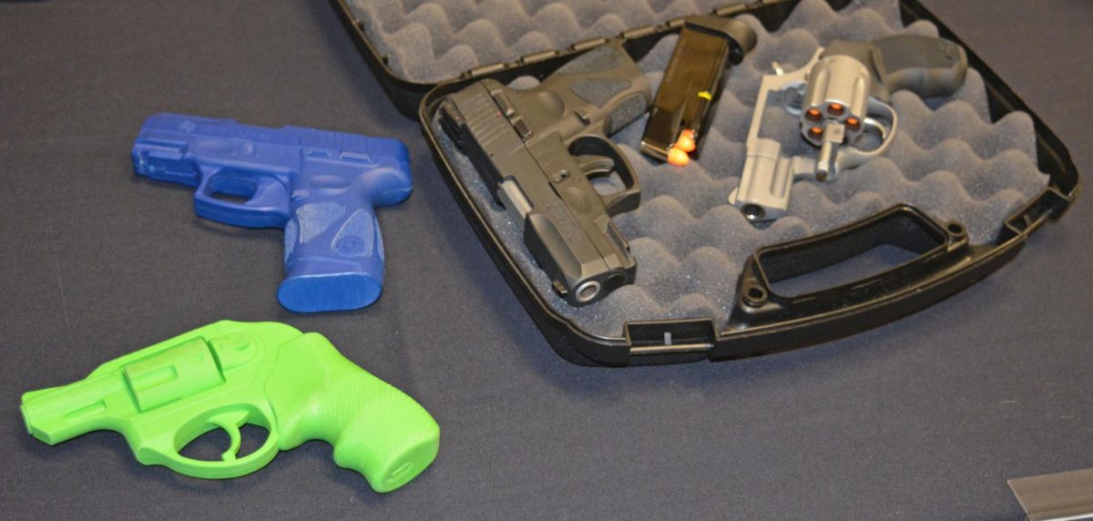 Unloaded handguns and plastic handgun replicas used at a concealed carry permit class helped demonstrate proper grip, technique and cleaning. (Photo by Caitlin Keith)