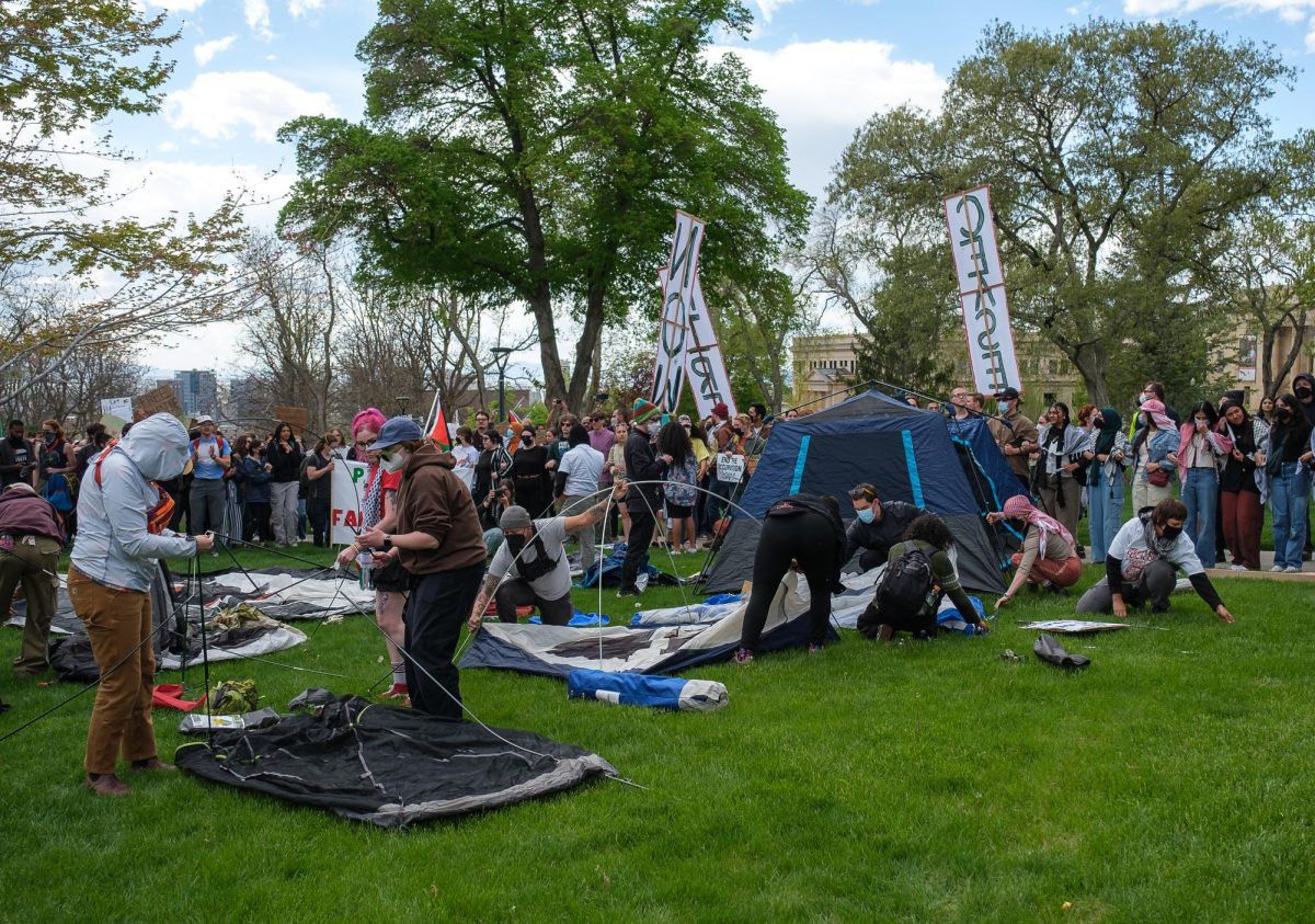 Pro-Palestine demonstrators assemble tents in front of the John R. Park Building at the University of Utah during the Emergency Rally For Palestine on Monday, April 29, 2024. (Photo by Marco Lozzi | The Daily Utah Chronicle)