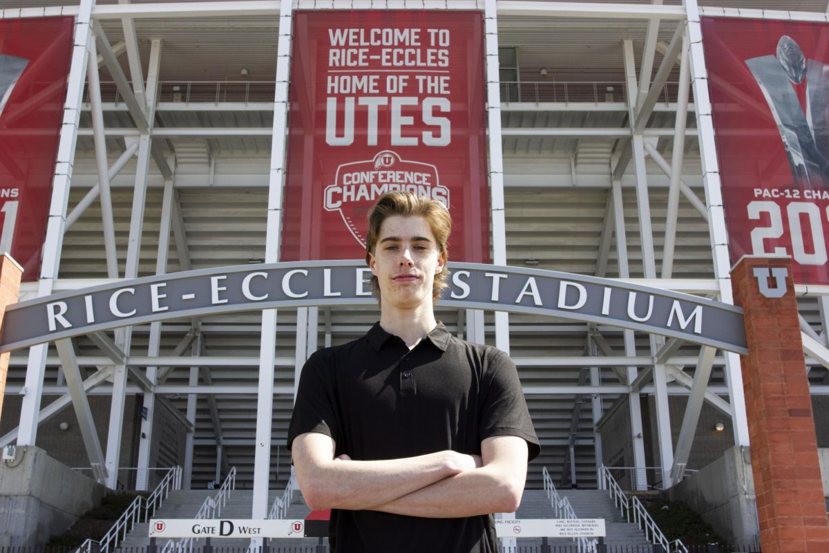 Sean Overton poses for a photo in front of Rice-Eccles Stadium (photo by Sarah Karr | Daily Utah Chronicle