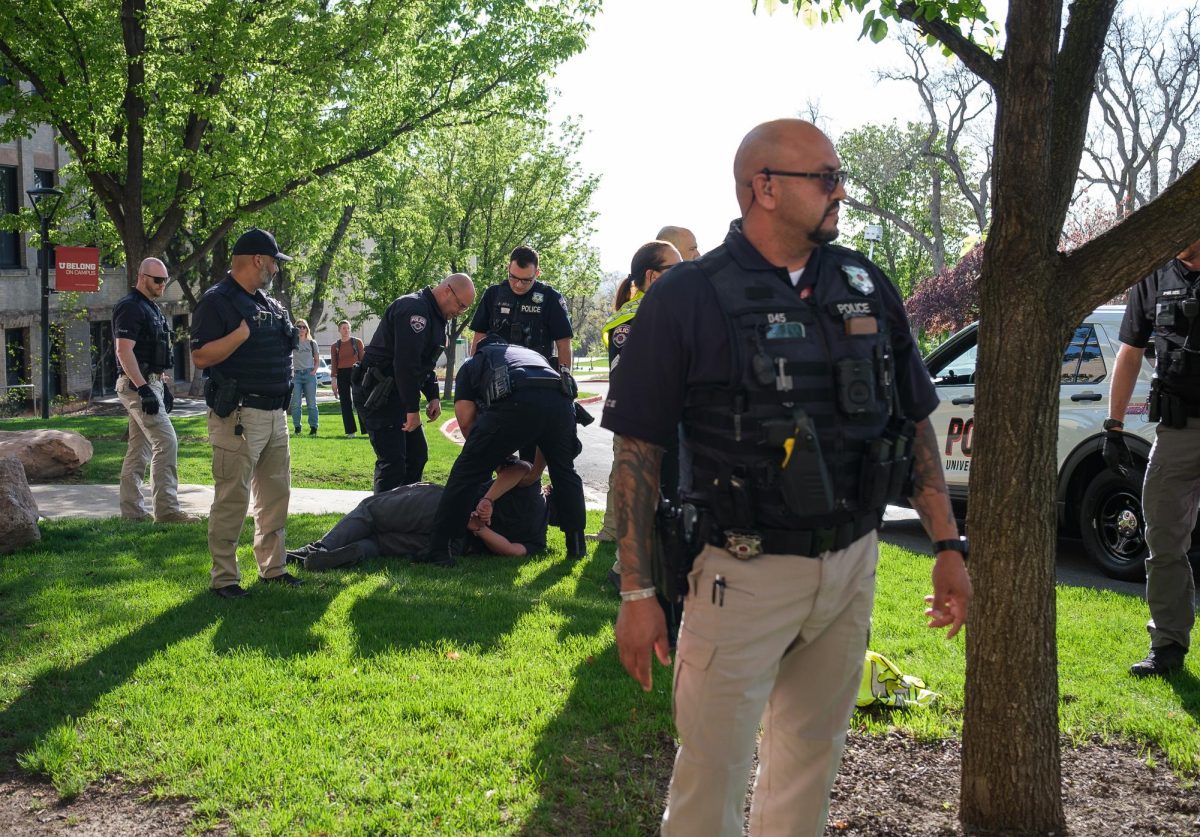 University of Utah police arrest a pro-Palestine demonstrator in front of the James Talmage Building at the University of Utah during the Defend the Students Stand with Palestine rally on Tuesday, April 30, 2024. (Photo by Marco Lozzi | The Daily Utah Chronicle)