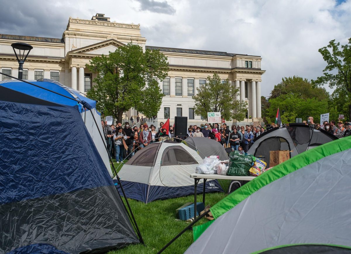 Pro-Palestine demonstrators organize around a newly built encampment in front of the John R. Park Building at the University of Utah during the Emergency Rally For Palestine on Monday, Apr. 29, 2024. (Photo by Marco Lozzi | The Daily Utah Chronicle)