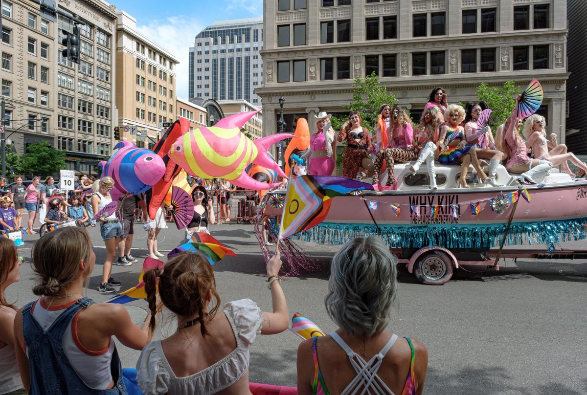 Parade goers cheer for parade participants during the 2024 Utah Pride Parade in downtown Salt Lake City on Friday, June 2, 2024. (Photo by Marco Lozzi | The Daily Utah Chronicle)