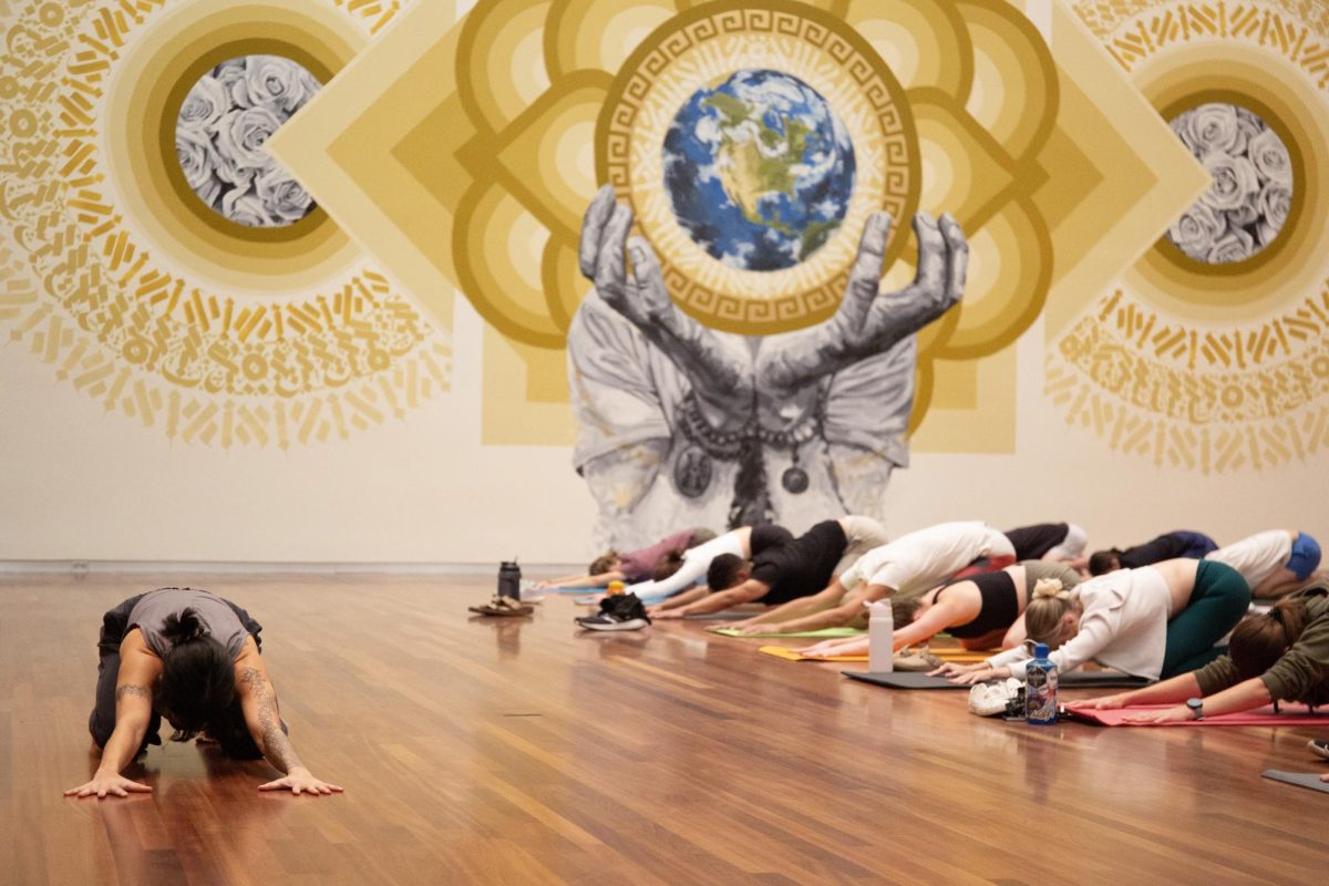 Students participate in a weekly yoga session hosted by Art + Wellness at the Utah Museum of Fine Arts in Salt Lake City on Sept. 11, 2024. (Photo by Addy Cowley | The Daily Utah Chronicle)