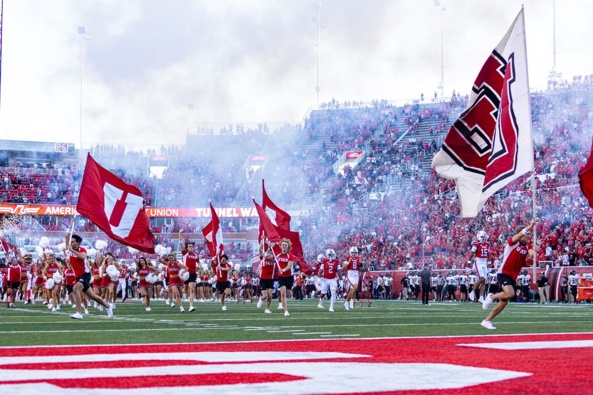 The Marching Utes and the Utah Spirit and Cheer Teams during the pre-game run out at the University of Utah's home opener football game versus Southern Utah University at Rice-Eccles Stadium in Salt Lake City on Aug. 29, 2024. (Photo by Samantha Lazenby | The Daily Utah Chronicle) 