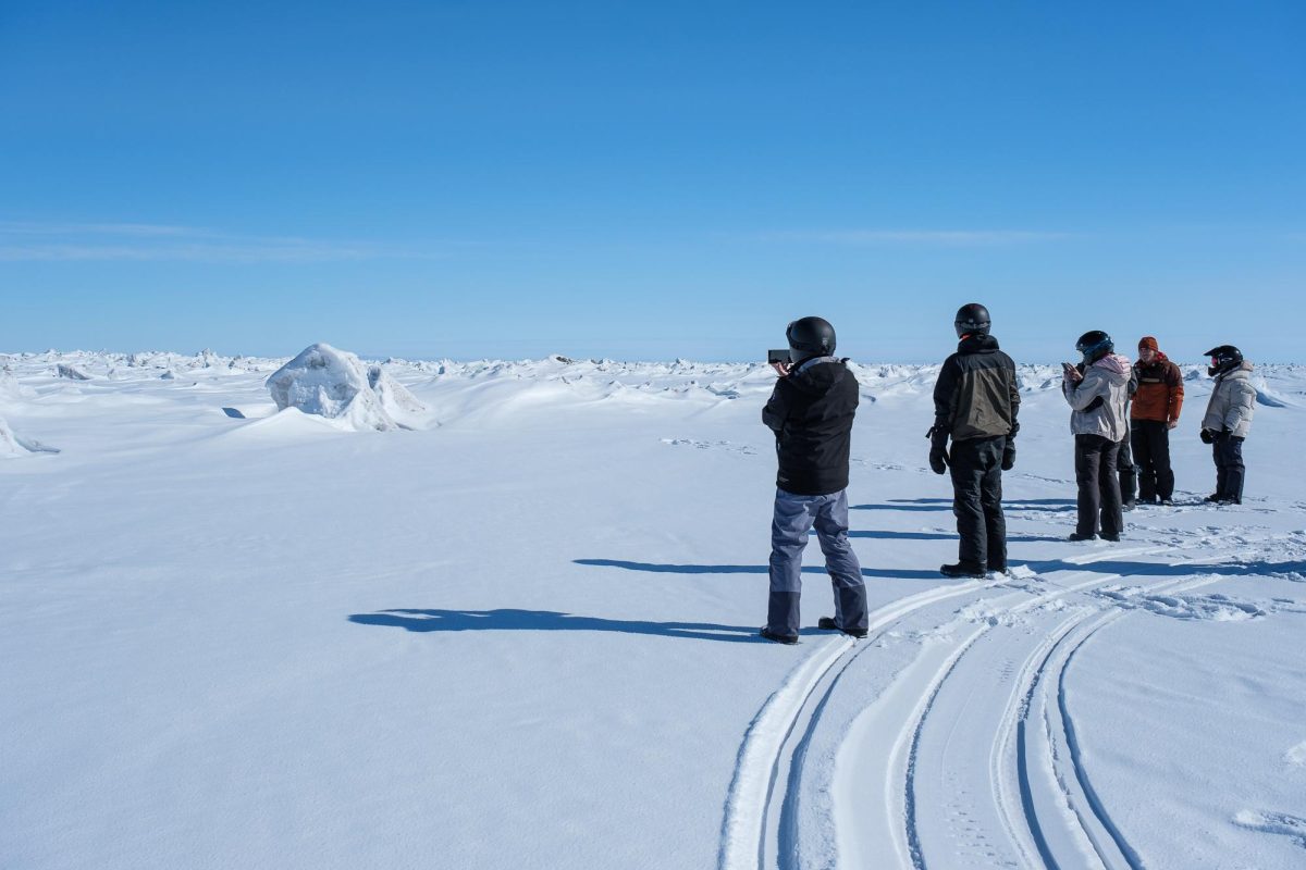 A group of researchers gaze at the vast, frozen Arctic Ocean northeast of Utqiaġvik, Alaska on Friday, May 10, 2024. (Photo by Marco Lozzi | The Daily Utah Chronicle)