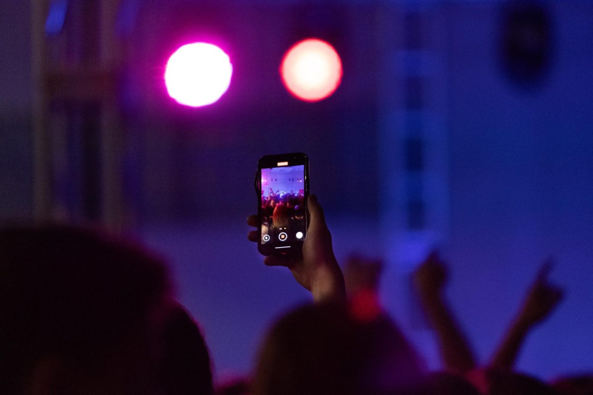 A student records Ritt Momney during RedFest at the University of Utah in the A. Ray Olpin Student Union Ballroom in Salt Lake City on Nov. 15, 2024. (Photo by Addy Cowley | The Daily Utah Chronicle)