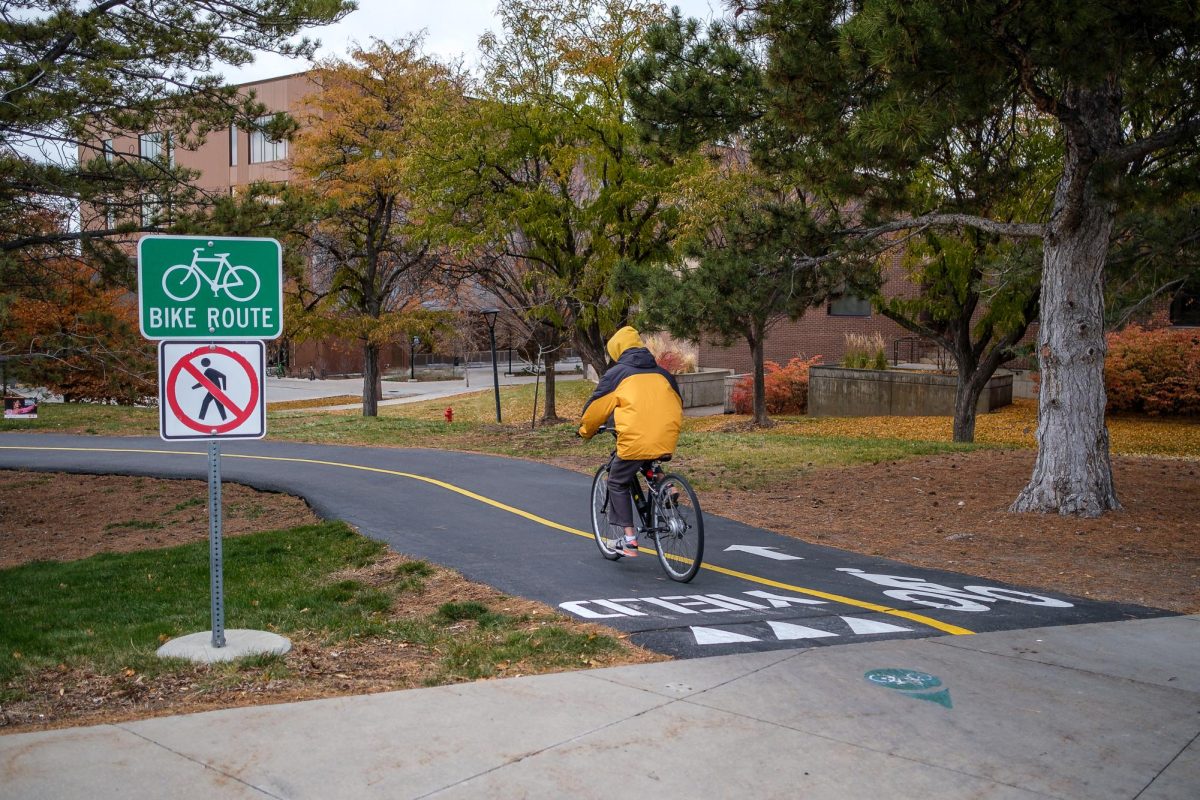 A student rides a bike down campus at the University of Utah in Salt Lake City on Monday Nov. 25, 2024. (Photo by Marco Lozzi | The Daily Utah Chronicle)