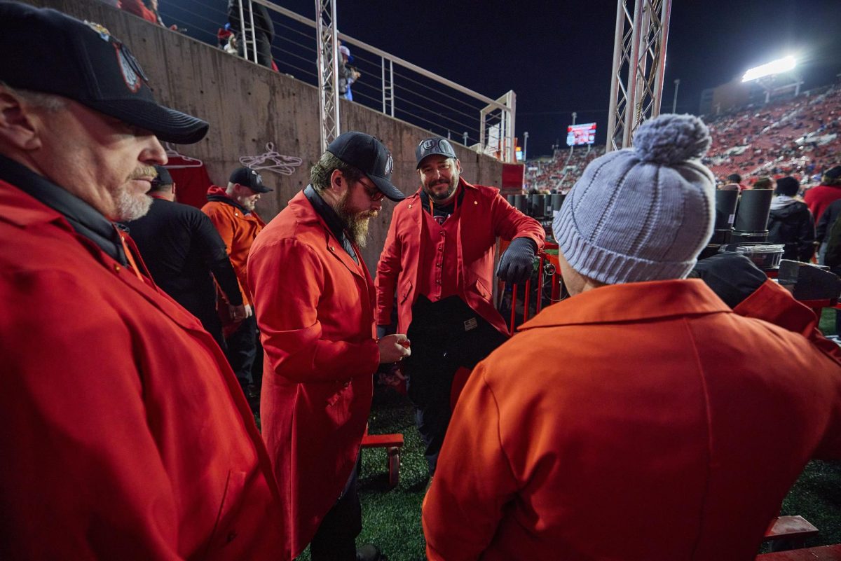 Ryan Bigler (center), a team member of the 801 Pyros, waits to push firework charges onto the field before run on of the U vs. BYU game in the Rice-Eccles Stadium on Saturday, Nov. 9, 2024. (Photo by Luke Larsen | The Daily Utah Chronicle)