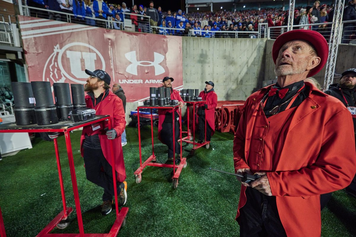 Chuck Johnson, commander and chief of the 801 Pyros, prepares to send fireworks charges onto the field before the fourth quarter of the U vs. BYU game in the Rice-Eccles Stadium on Saturday, Nov. 9, 2024. (Photo by Luke Larsen | The Daily Utah Chronicle)