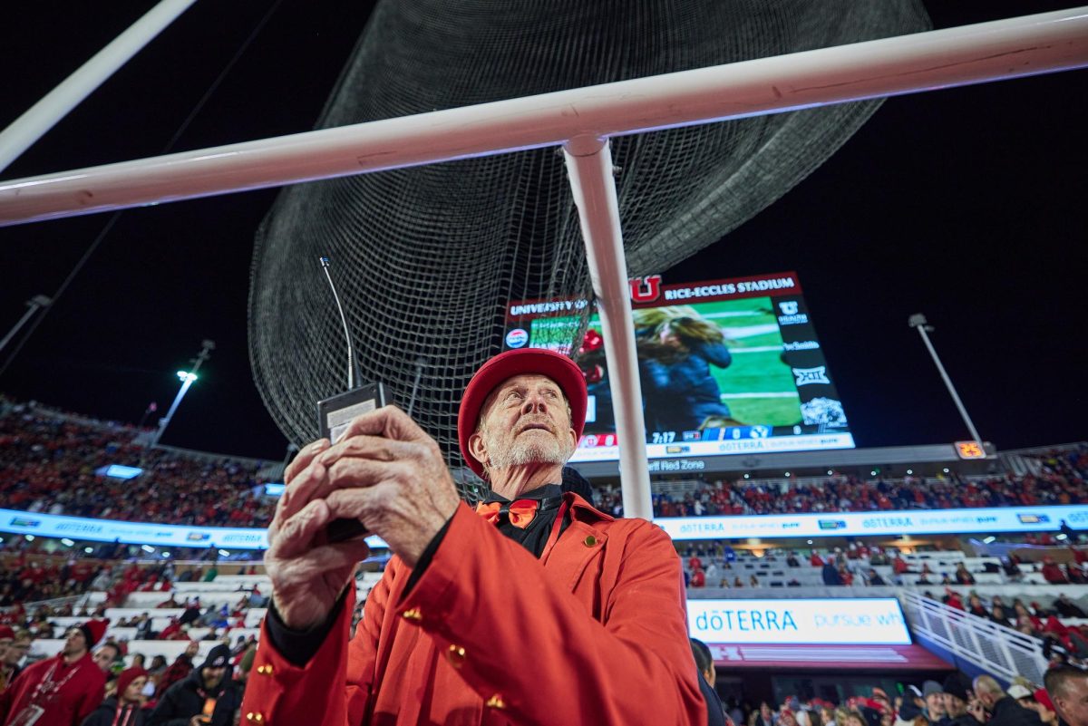 Chuck Johnson, commander and chief of the 801 Pyros, readies a detonator connected to multiple flares before the Utah Utes run on of the U vs. BYU game in the Rice-Eccles Stadium on Saturday, Nov. 9, 2024. (Photo by Luke Larsen | The Daily Utah Chronicle)