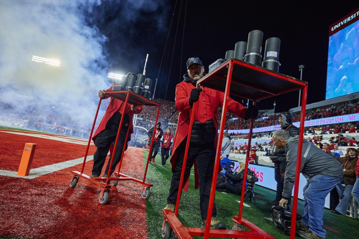 Russ Monsive pushes fireworks tubes off the field during the fourth quarter of the U vs. BYU game in the Rice-Eccles Stadium on Saturday, Nov. 9, 2024. (Photo by Luke Larsen | The Daily Utah Chronicle)